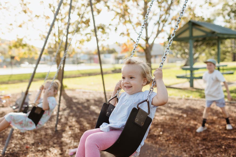 young girls on swing in park