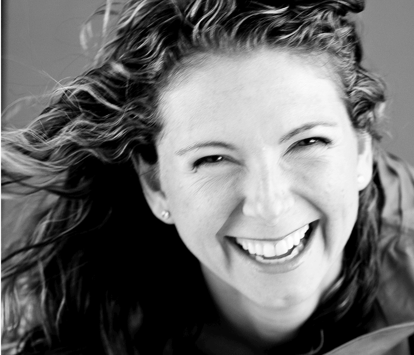 Black-and-white portrait of a smiling woman (L3 Coaching founder)