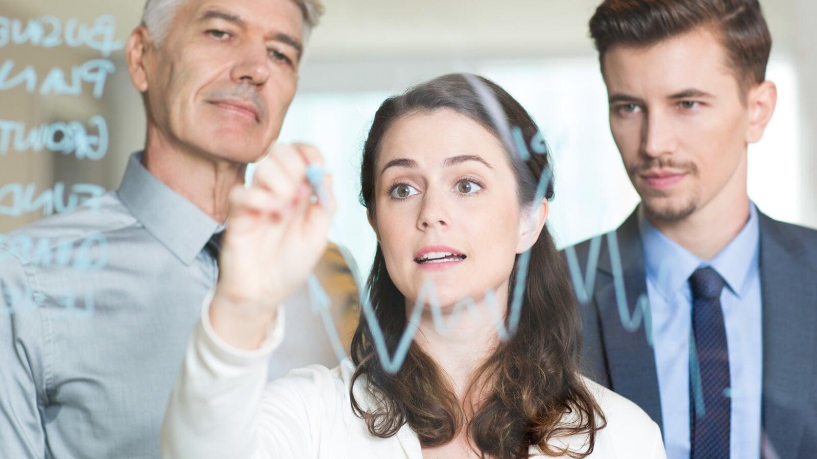 Leader presenting to a team with charts — leadership and decision-making